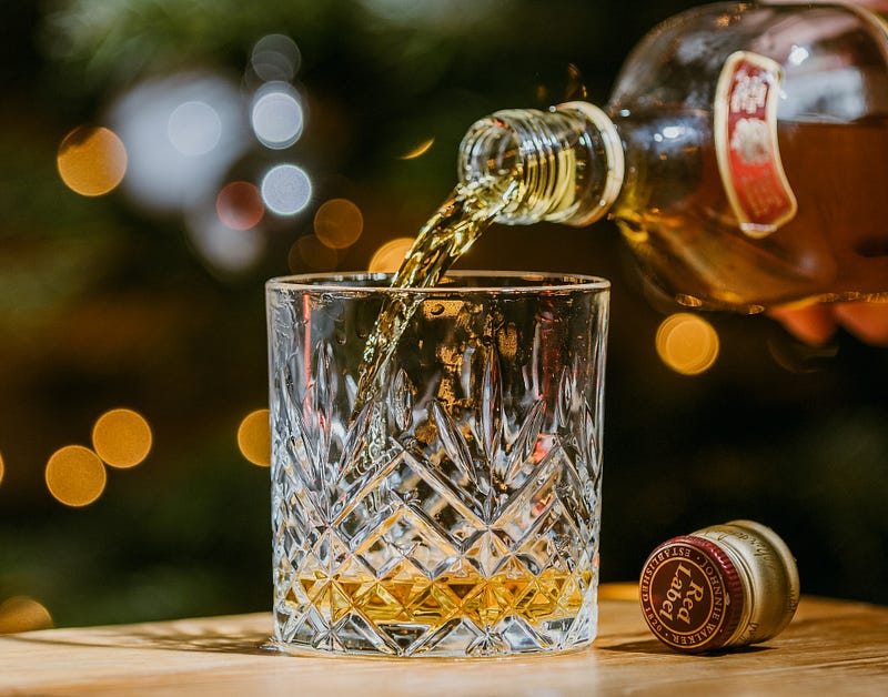 A glass of whiskey with ice, symbolizing relaxation