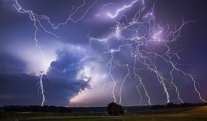 Sheet lightning illuminating a cloud