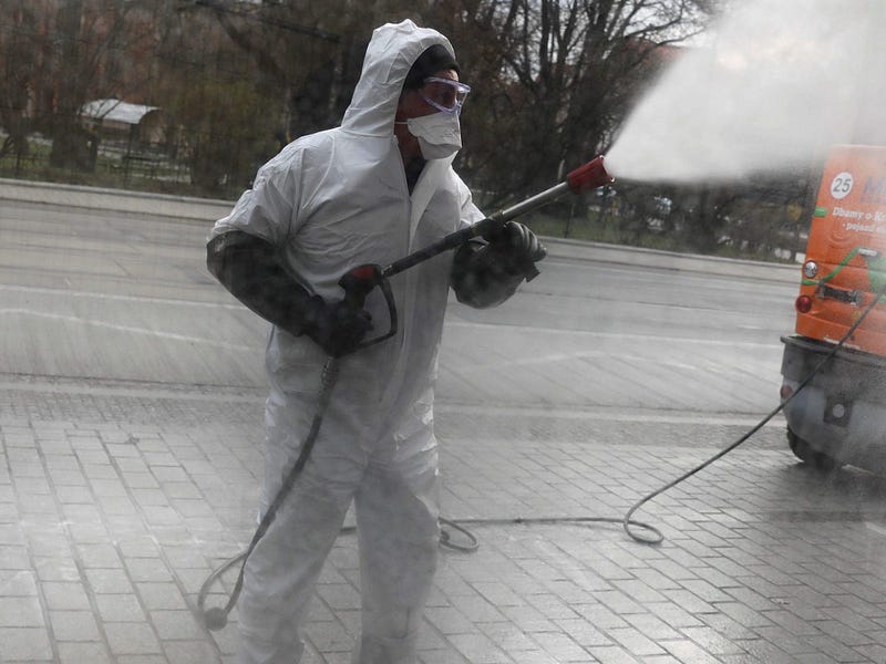 Worker disinfecting a bus stop during the pandemic